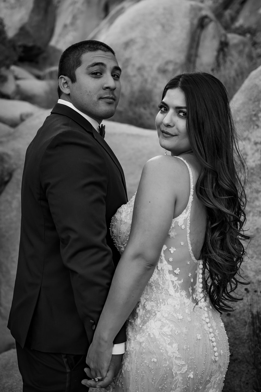 A romantic black and white wedding photo sequence showing a couple posing against a textured wall.