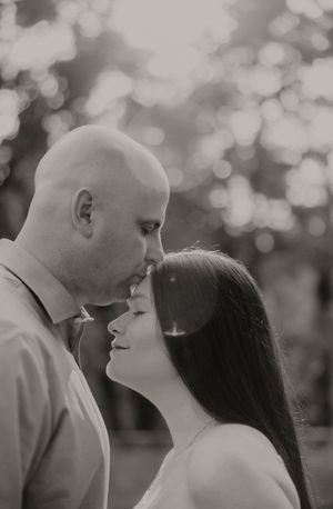 A romantic black and white photo series showing an intimate moment between a couple in soft bokeh lighting.