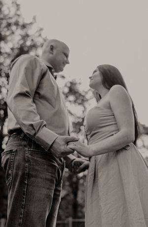 A black and white photo series showing tender moments between a couple in a park.