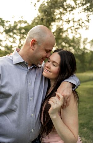 A romantic couple embracing during a golden hour photography session outdoors.