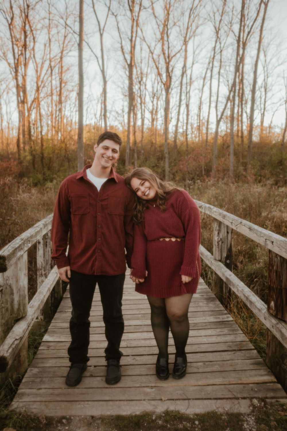 Four sequential photos show a couple in burgundy sweaters sitting and posing together on a wooden boardwalk in autumn.