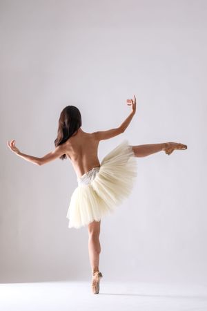 Contemporary ballet performance featuring flowing movements in a minimalist white studio setting.