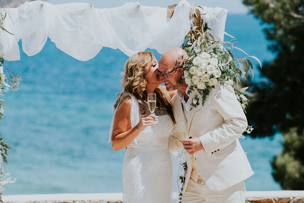 A joyful moment shared during an oceanfront wedding ceremony.