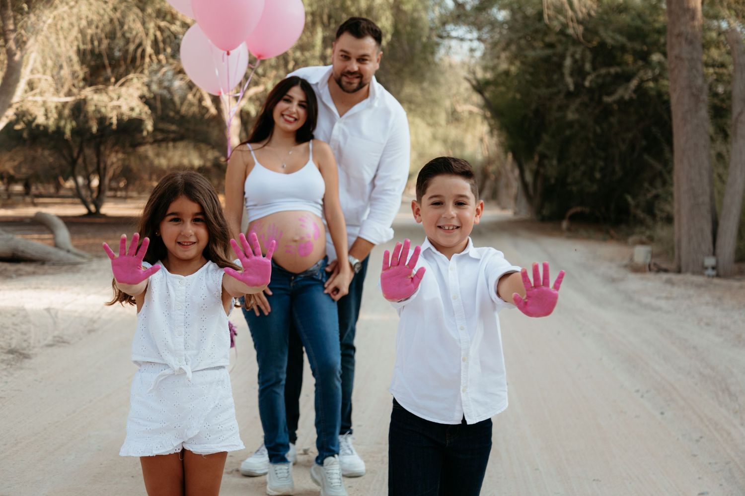 maternity photoshoot pink paint gender reveal photoshoot in abu dhabi beach