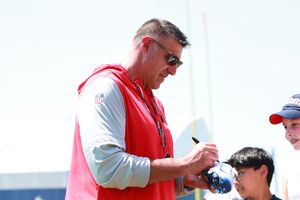 Fans gather for autographs and photos at football training camp event.
