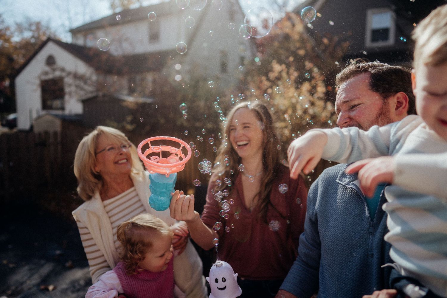A series of candid outdoor party photos showing people laughing and socializing in natural sunlight.