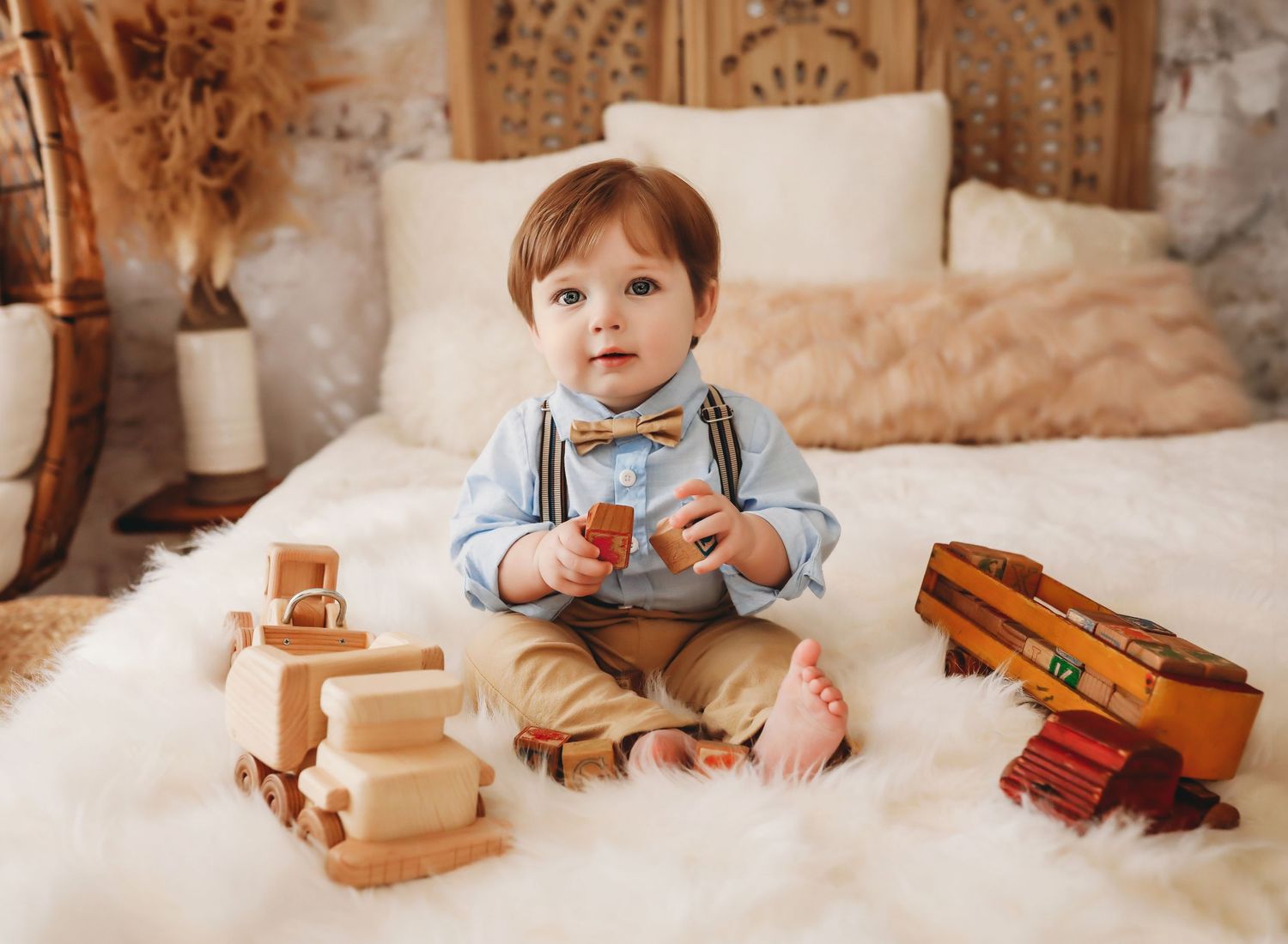 Wooden toy blocks and natural toys arranged in a cozy neutral setting with soft lighting and cream-colored backdrop.