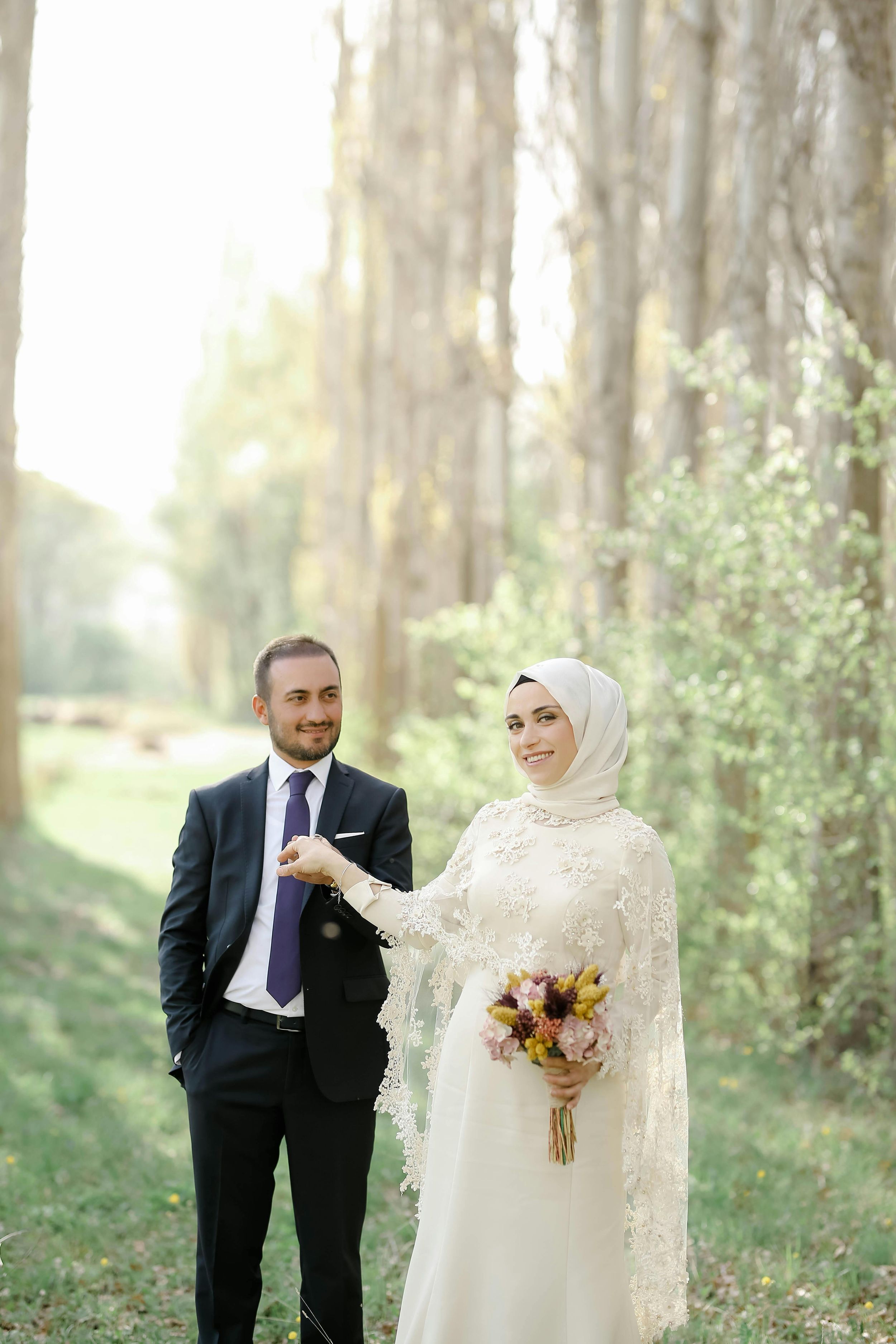 A romantic wedding photo collage showing a couple in traditional attire posing together in a sunlit forest setting.