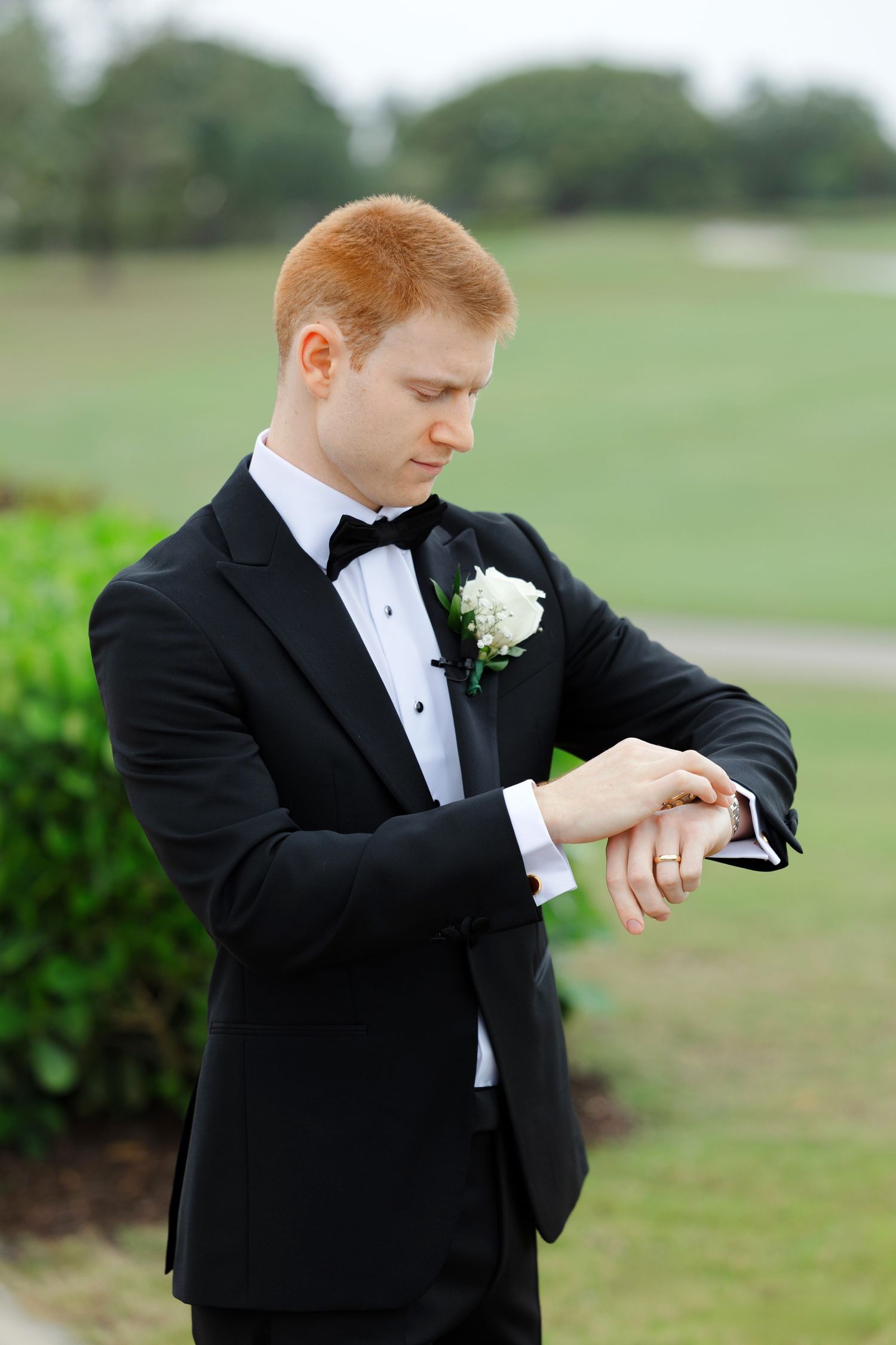 Groom adjusting watch at BallenIsles Country Club in Palm Beach during a wedding photographed by Ohio photographer Tom Forrest.