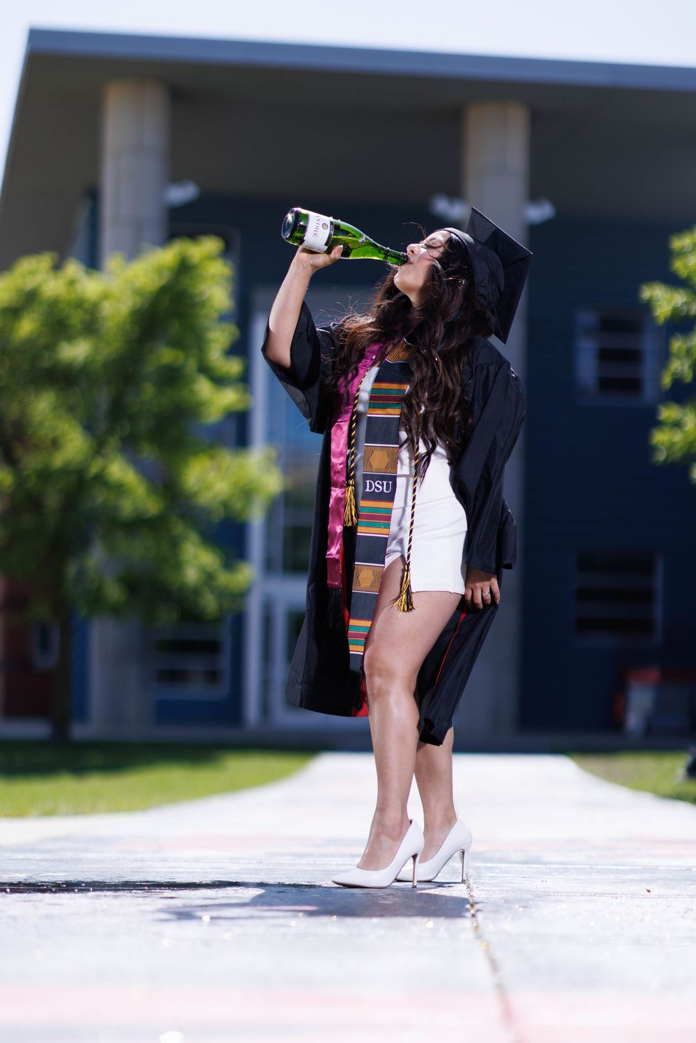 A series of graduation photos showing creative poses in white heels and regalia.
