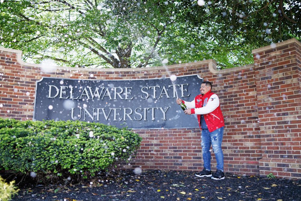 Delaware State University brick entrance sign with red balloons.