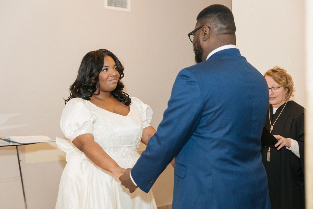 Wedding photo sequence capturing intimate moments between a couple in a white-walled corridor.