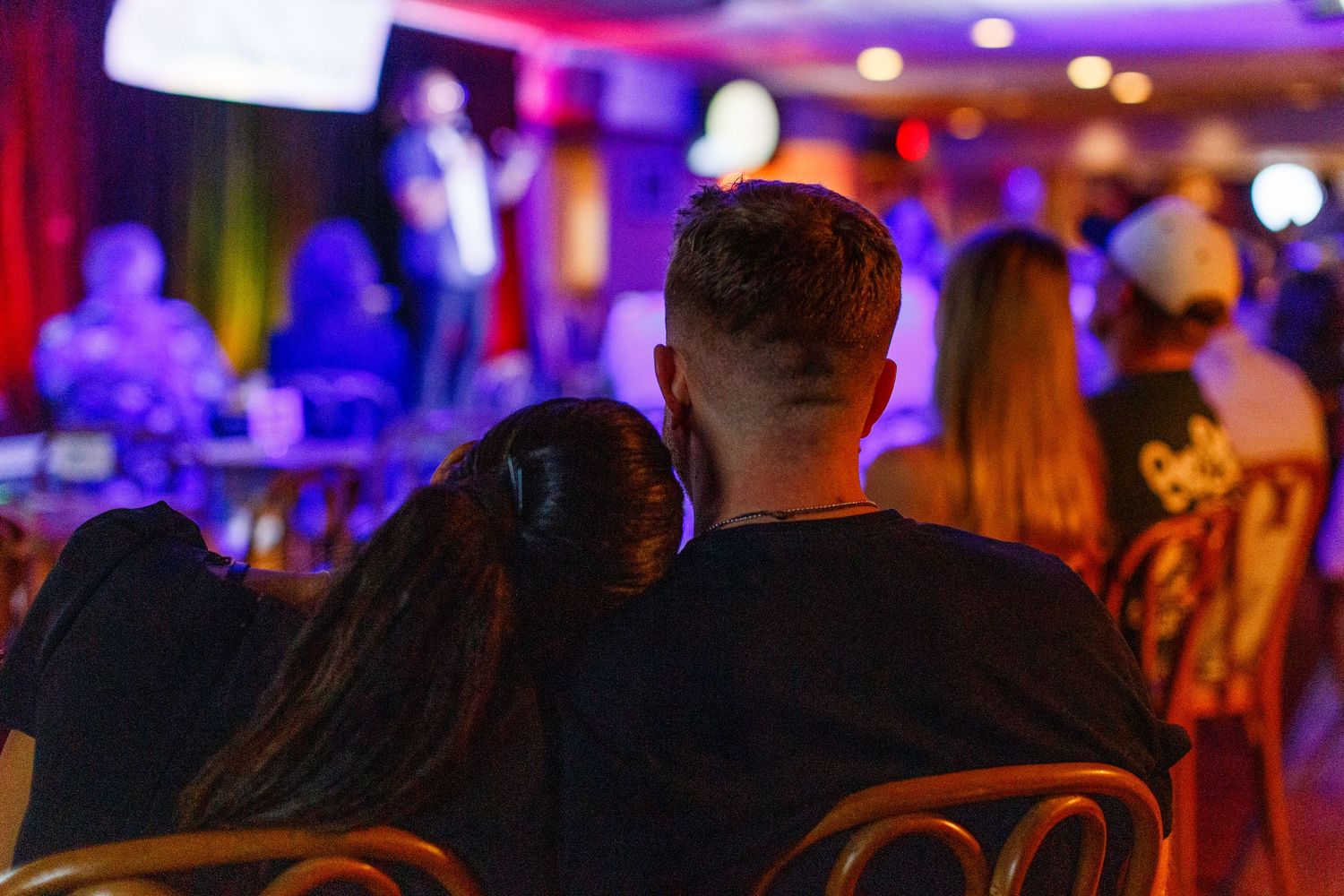 Couple watching a comedy show. San Juan, Puerto Rico.