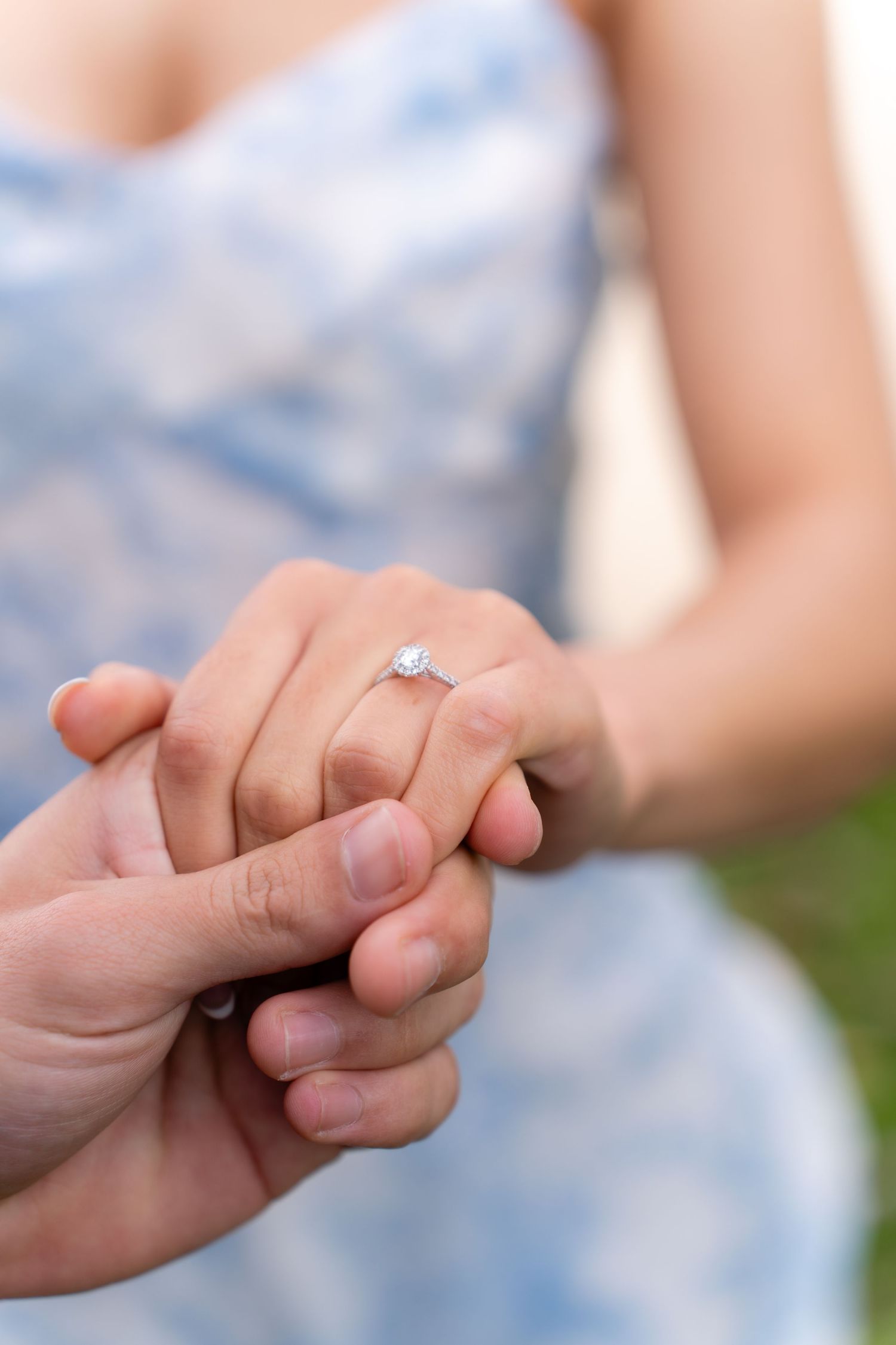 Hands holding with an engagement ring visible and text overlay reading We Capture Love For Living.