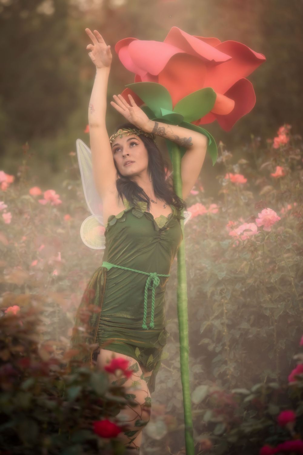 Dreamy fantasy photoshoot with a rose prop during golden hour in the Rose Garden At Manito Park in Spokane Washington.
