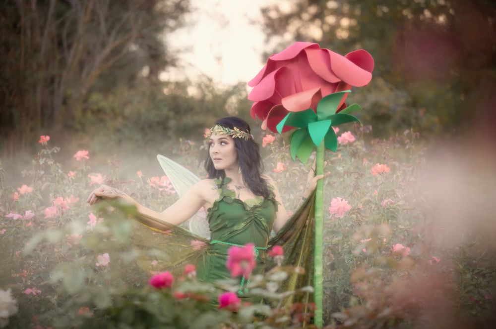 Dreamy fantasy photoshoot with a rose prop during golden hour in the Rose Garden At Manito Park in Spokane Washington.
