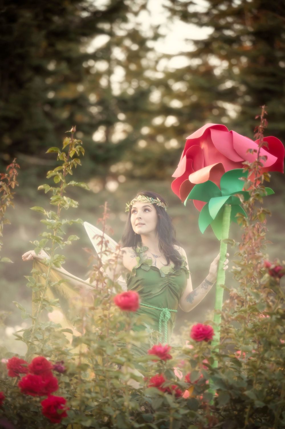 Dreamy fantasy photoshoot with a rose prop during golden hour in the Rose Garden At Manito Park in Spokane Washington.