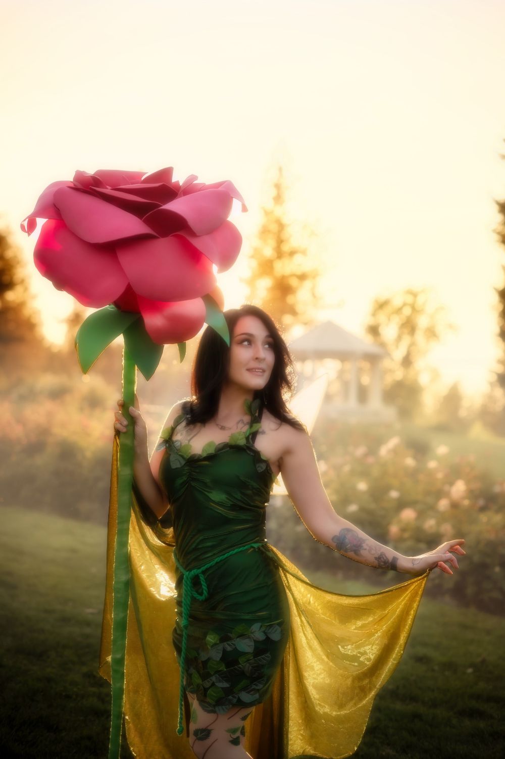 Dreamy fantasy photoshoot with a rose prop during golden hour in the Rose Garden At Manito Park in Spokane Washington.
