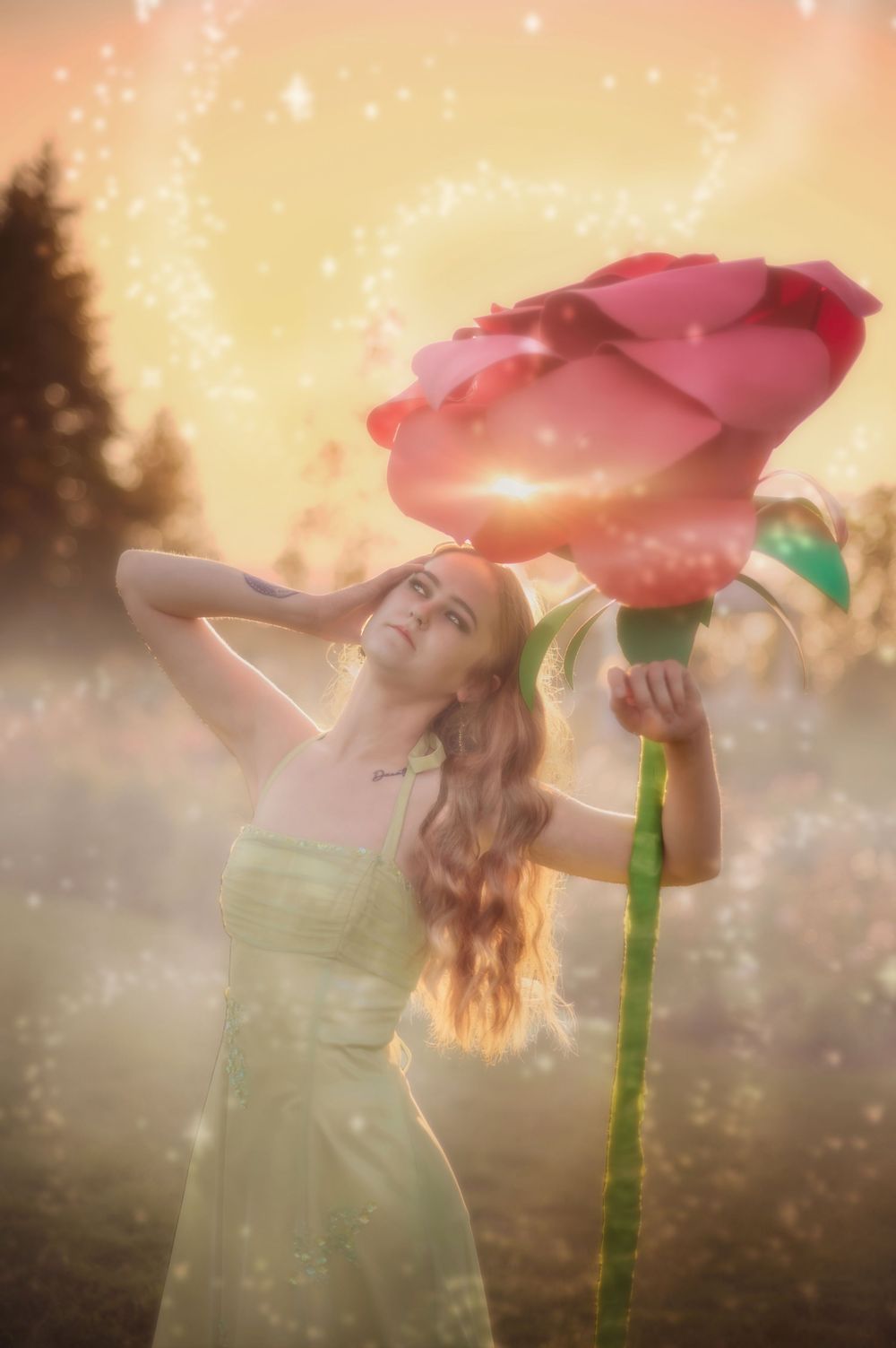 Dreamy fantasy photoshoot with a rose prop during golden hour in the Rose Garden At Manito Park in Spokane Washington.