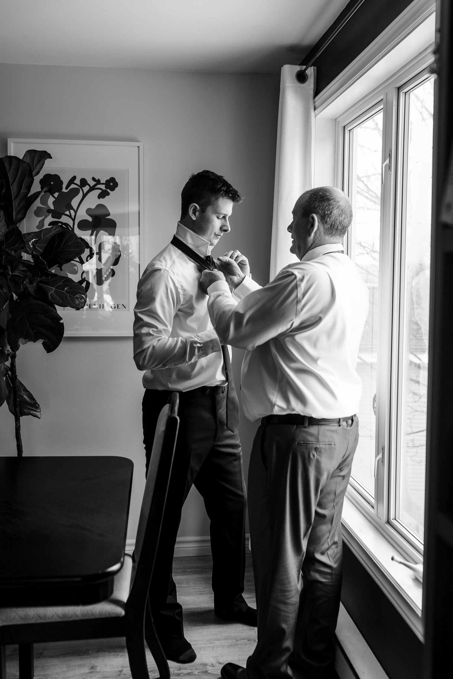 A black and white photo series showing two people dancing together by a window in what appears to be a dance lesson.