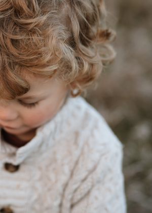 Curly brown hair in close-up macro shot showing natural texture and waves at fall session in Palatine