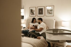A series of lifestyle photos showing cozy indoor moments in warm sepia tones of family with a newborn