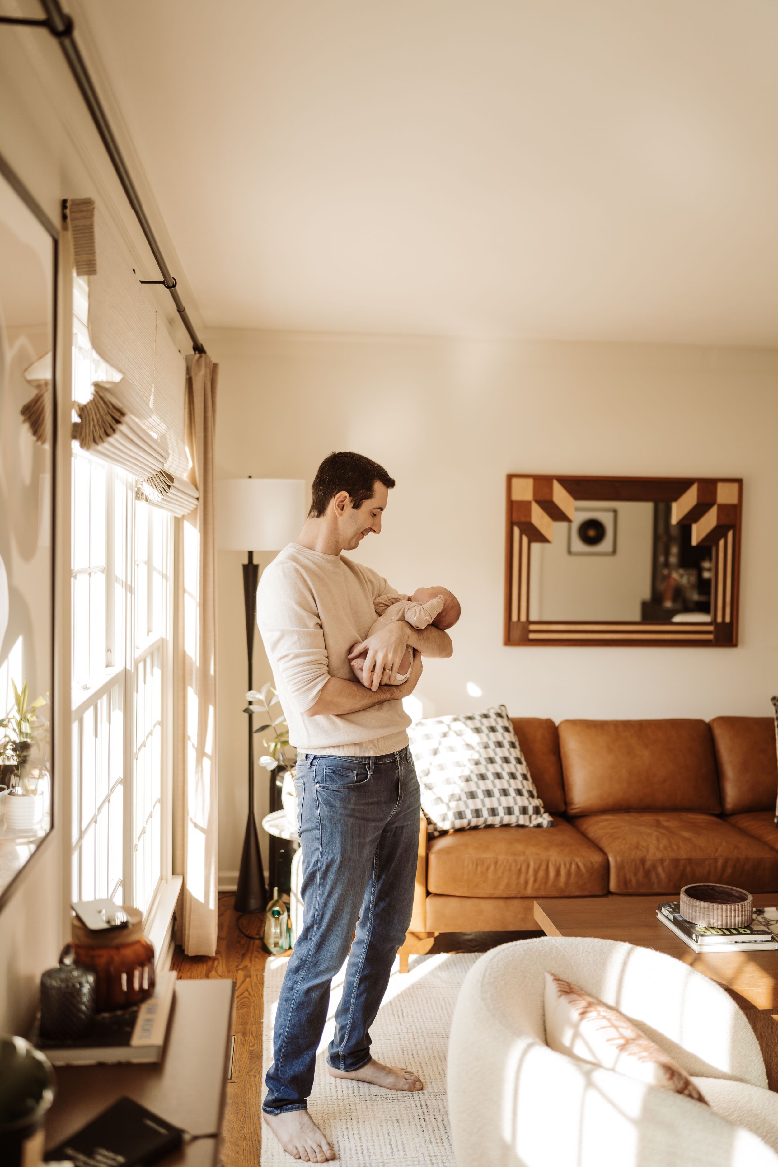 A dad and a newborn baby in home during lifestyle session