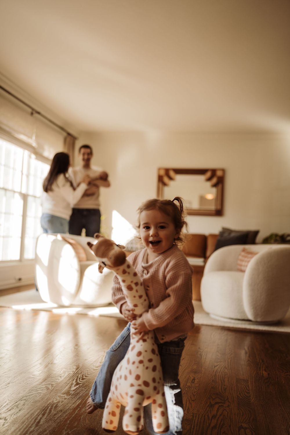 A little girl with her family behind at their family lifestyle session with a newborn in Rolling Meadows