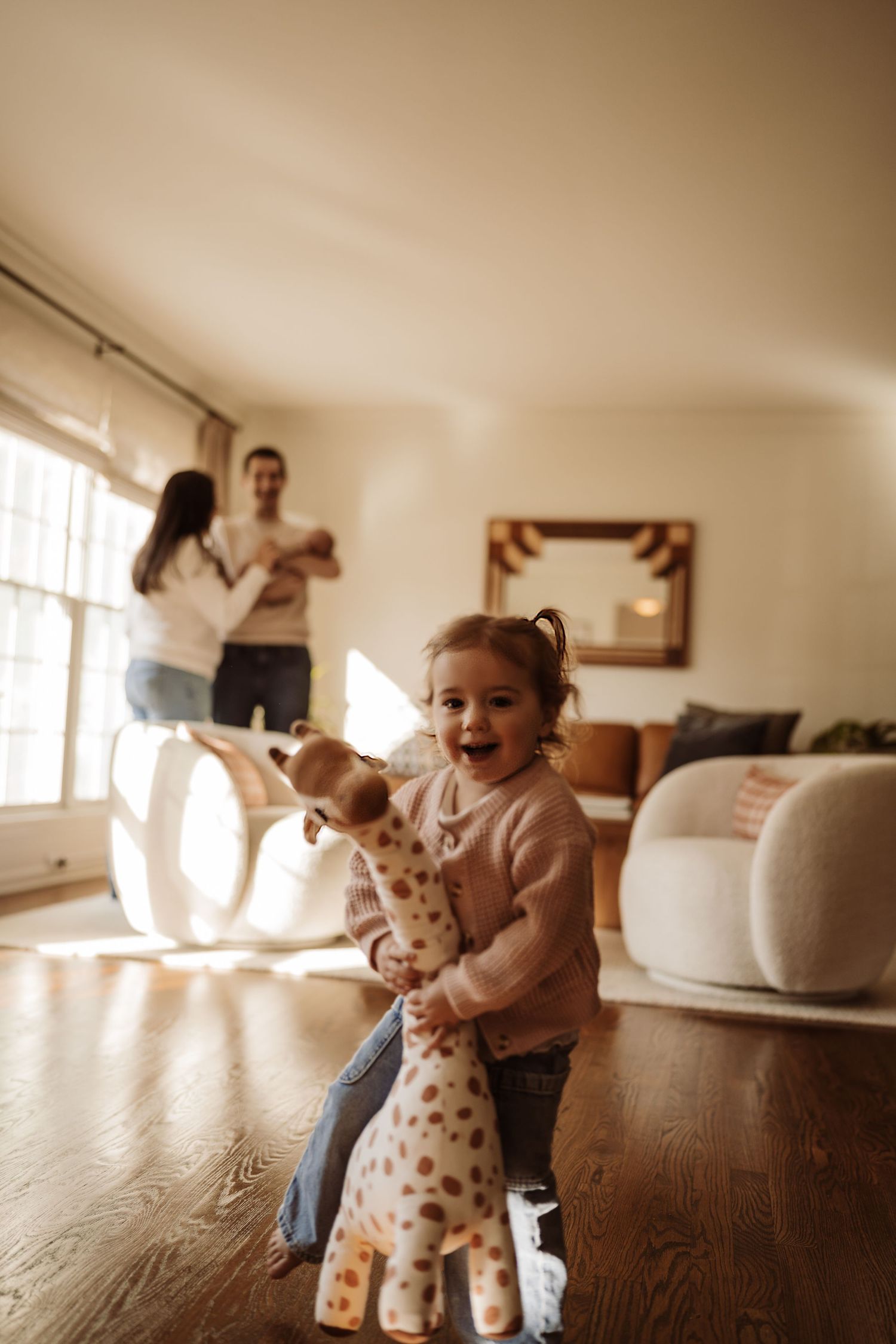 A little girl with her family behind at their family lifestyle session with a newborn in Rolling Meadows