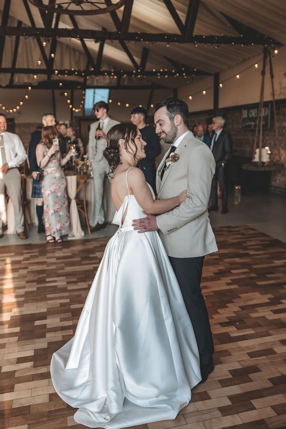 Unobtrusive wedding photography of newlyweds during their first dance.