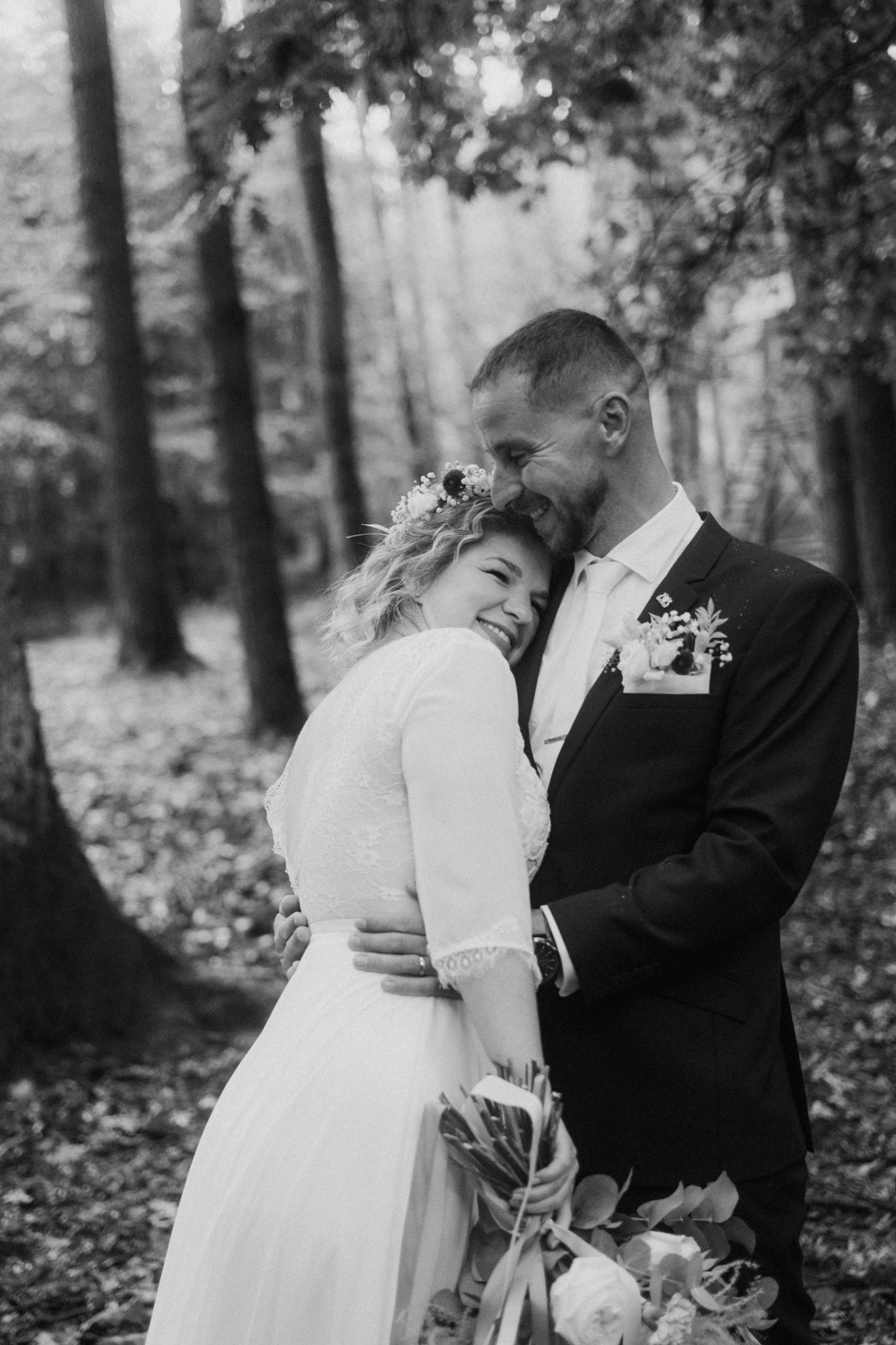 Black and white forest wedding portraits showing intimate moments between newlyweds.
