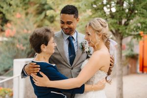A couple shares intimate moments during their outdoor wedding celebration in a garden setting.