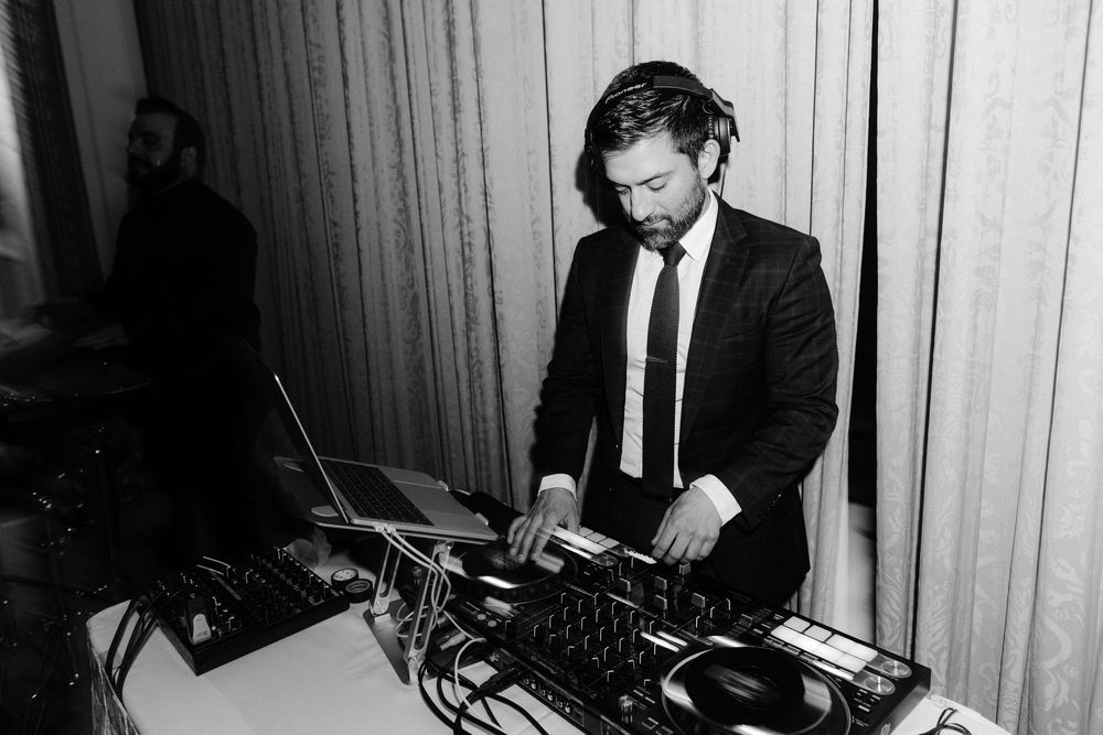 A series of black and white photos showing someone playing the theremin electronic instrument in different poses.