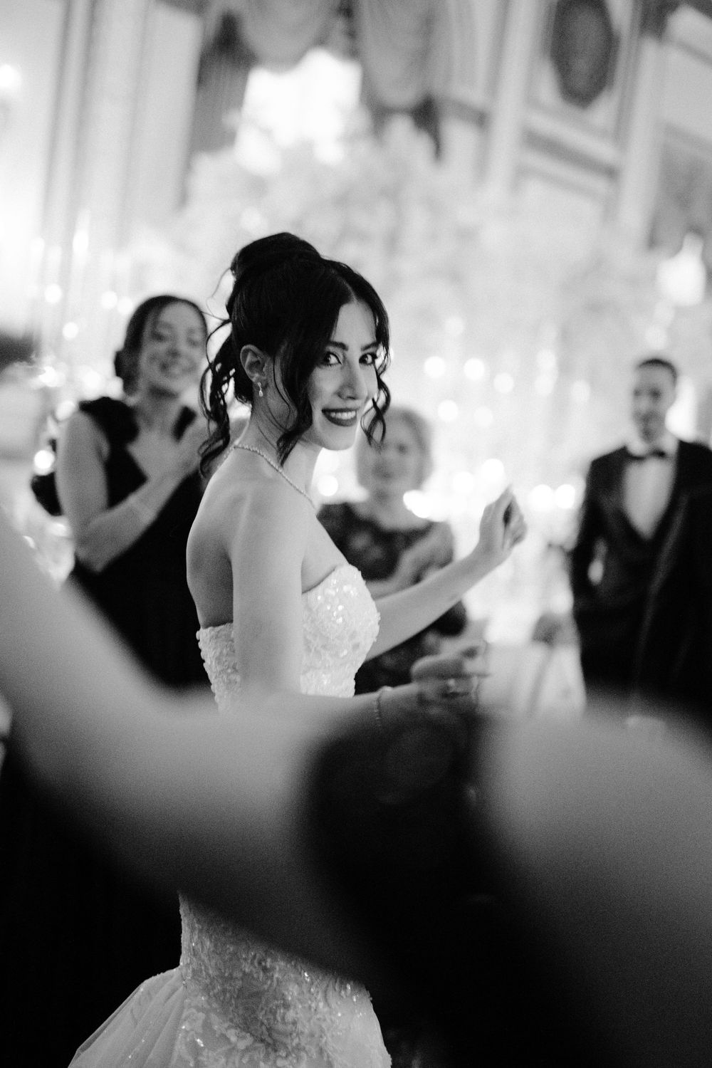 Black and white wedding reception photo showing a couple dancing together at their celebration.