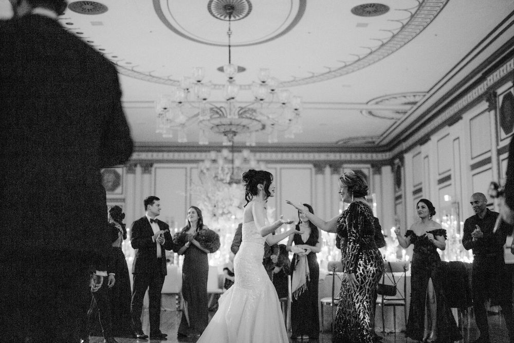 A sequence of black and white wedding reception photos showing couples dancing and celebrating in an elegant ballroom.