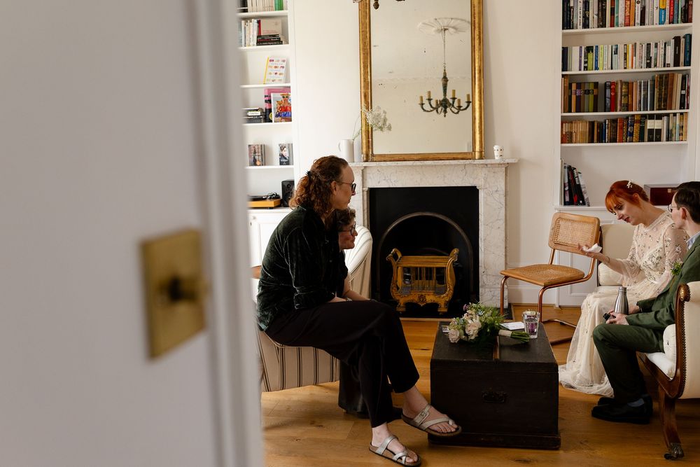 Interior scene of a cozy living room with bookshelves and natural light streaming through windows.