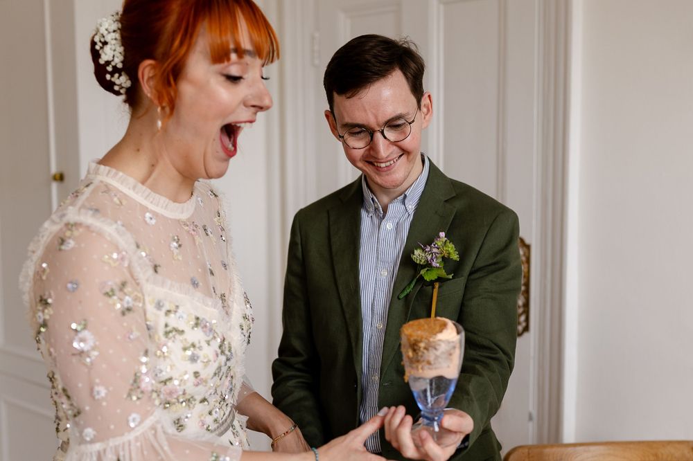 A happy couple shares a joyful moment during their wedding celebration with white floral decor.