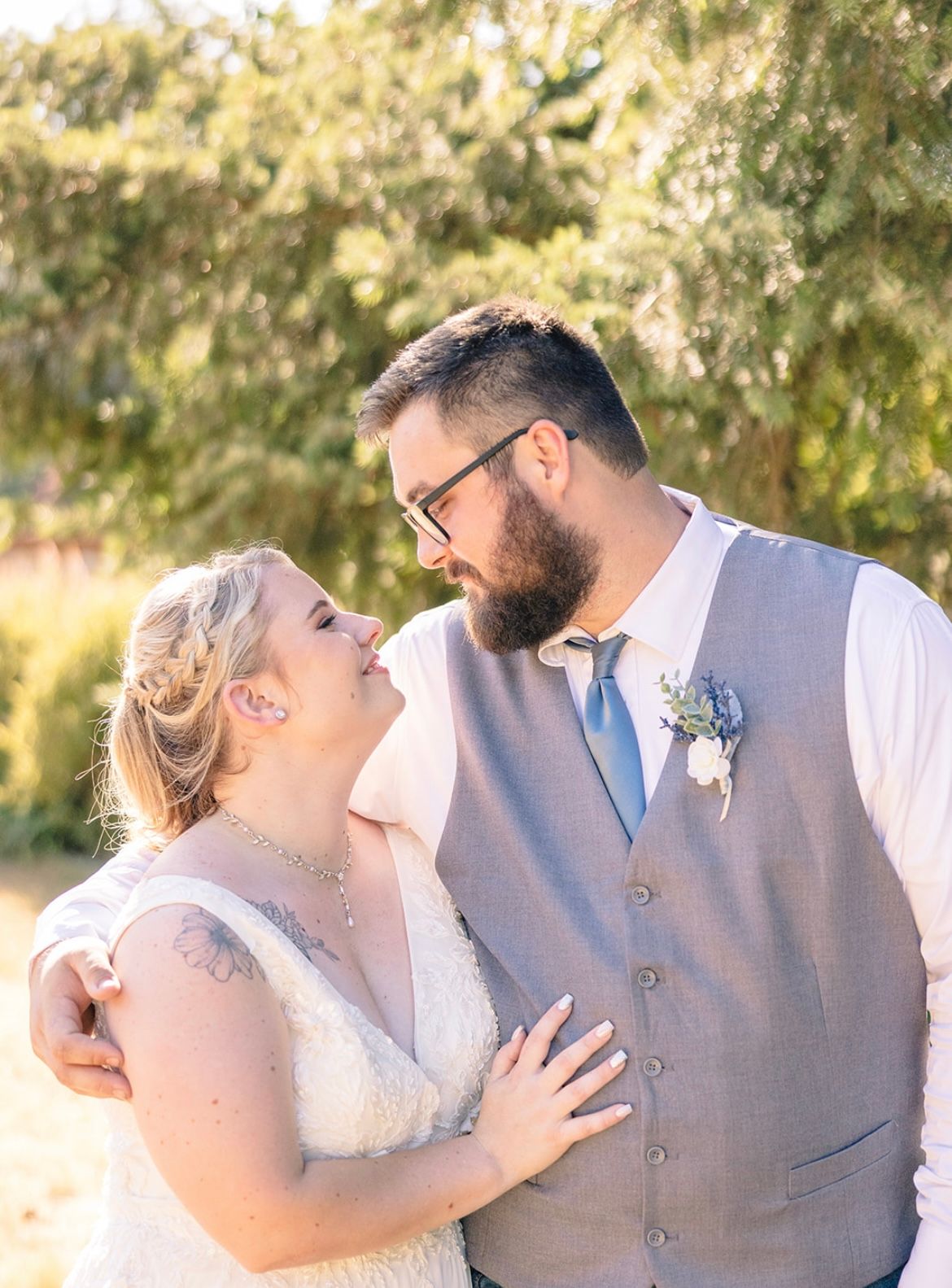 Romantic couple sharing intimate moments in an outdoor setting during golden hour.