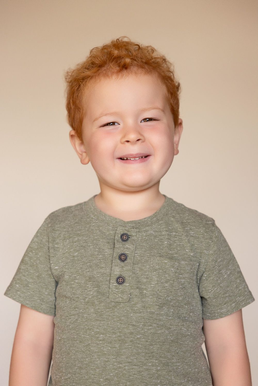 A child smiles brightly during Preschool Picture Day in the Bay Area