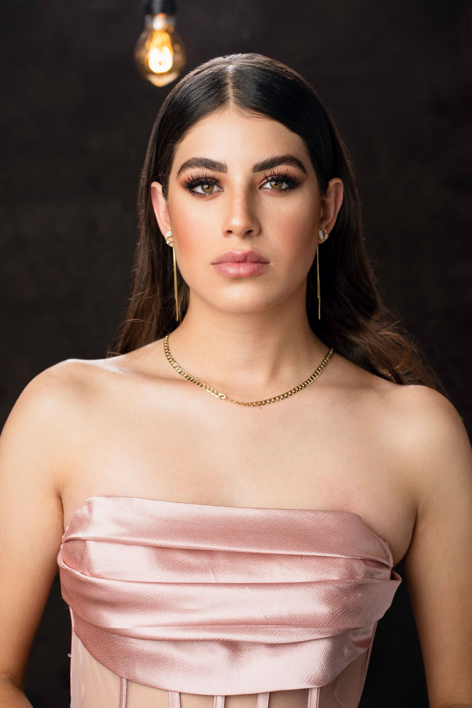 Strapless pink satin evening gown with folded neckline detail.