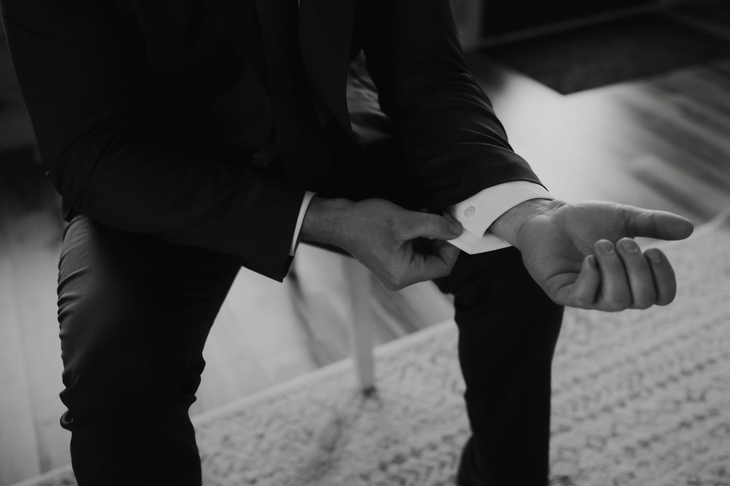 Wedding preparation details showing dress shoes and formal attire being put on.