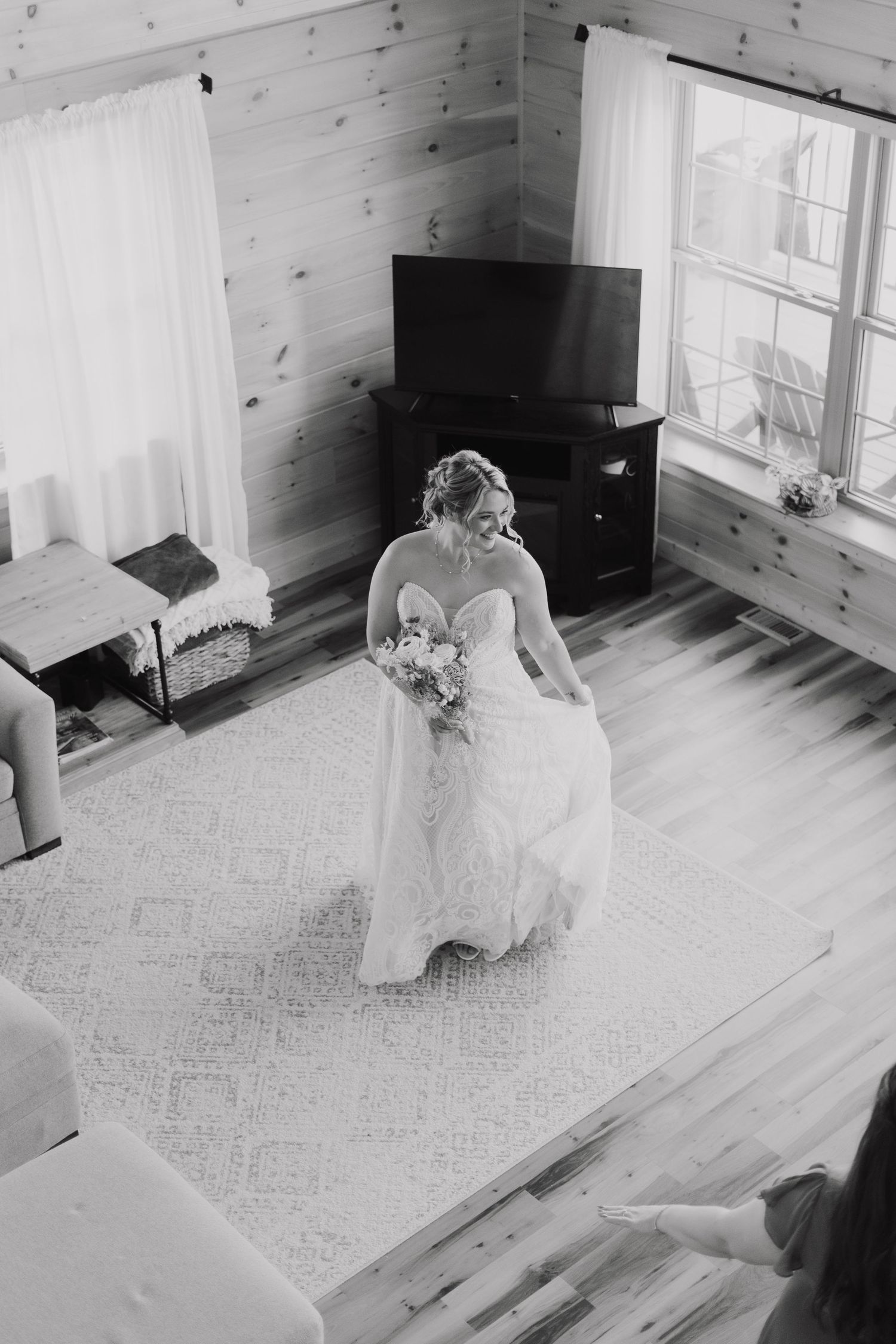 A sequence of black and white photos showing someone in a white dress sitting on a wooden floor near windows.