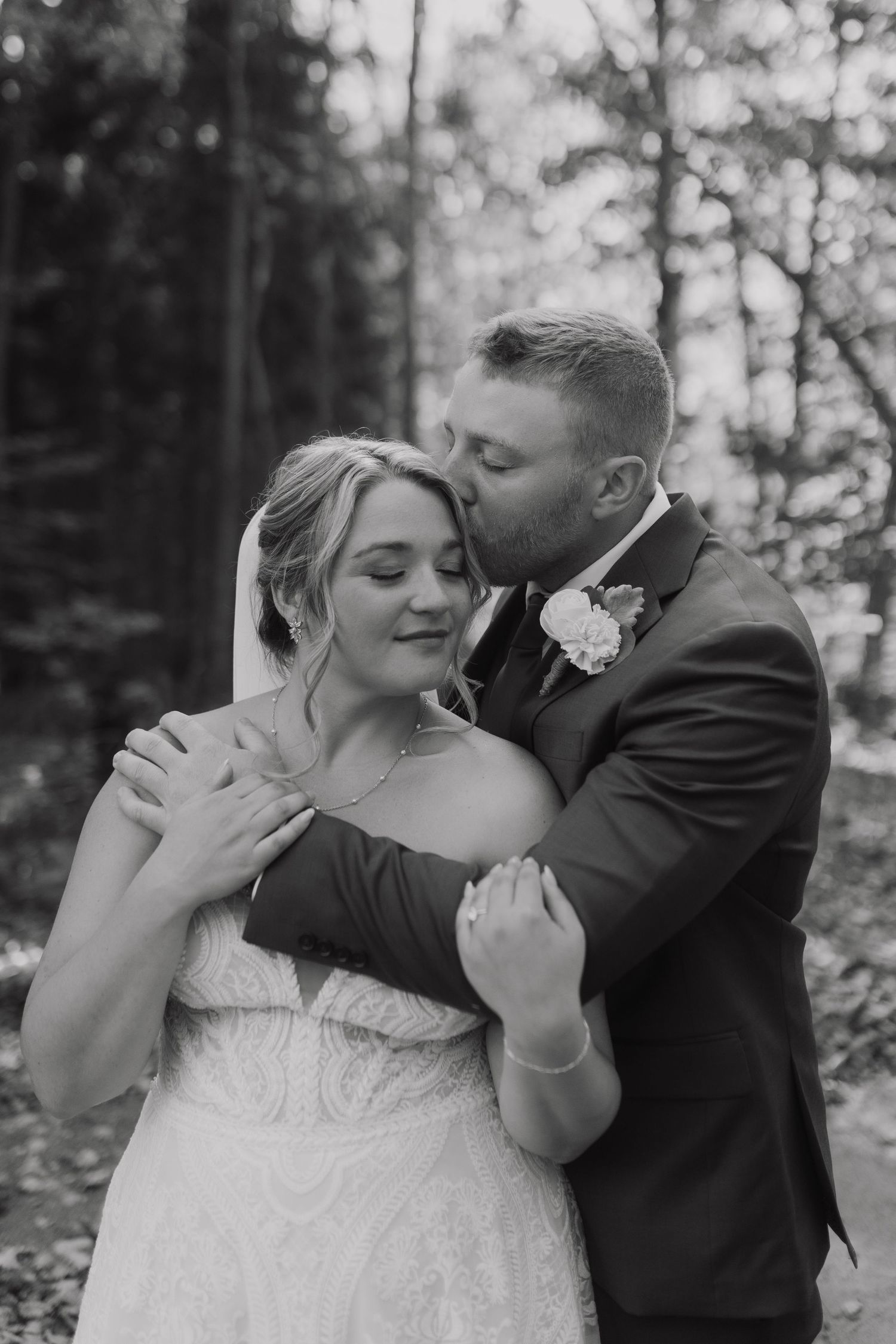 Romantic black and white wedding portraits showing intimate moments between newlyweds.