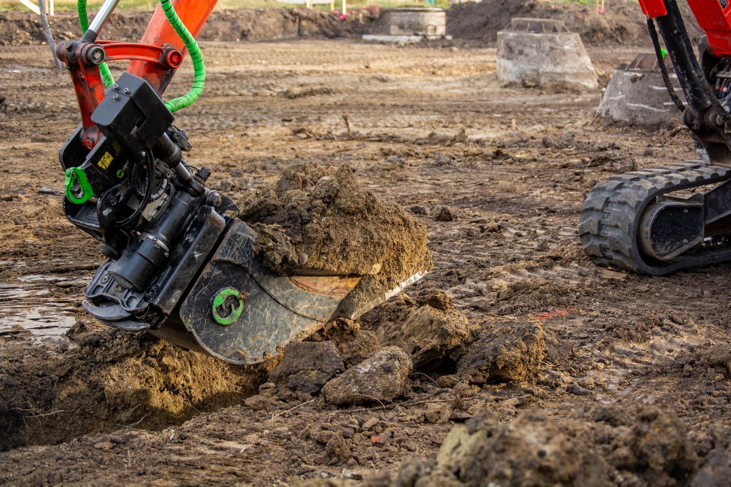 digging a pit with an excavator near a school for small space precision in the dirt ppe sherwood park trades and edmonton construction team