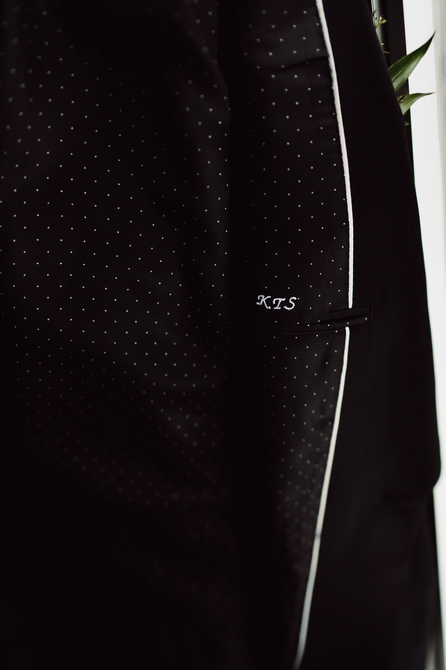 Close-up detail of black polka dot fabric texture with white accent.