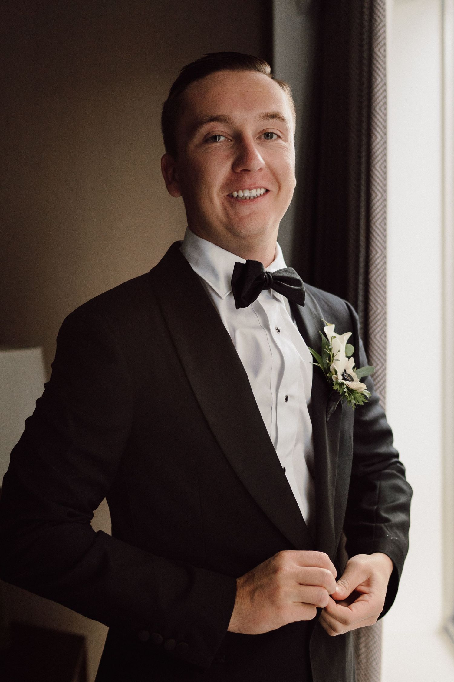 Series of getting ready shots showing groom adjusting formal black tuxedo.