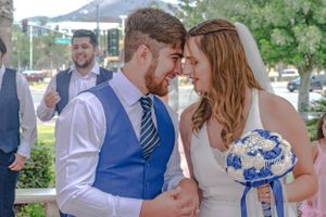 Wedding couple and guests share intimate moments during an outdoor celebration.