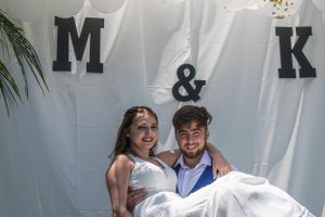 Wedding decorations featuring large monogram letters M & K against a white backdrop.