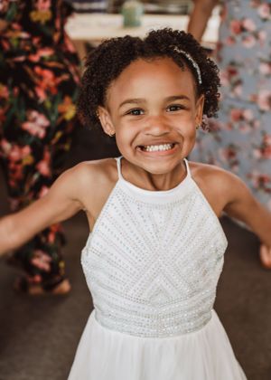 Flower girl posing for wedding photography captured by southern Maryland wedding photographer Mallory Bramlett.