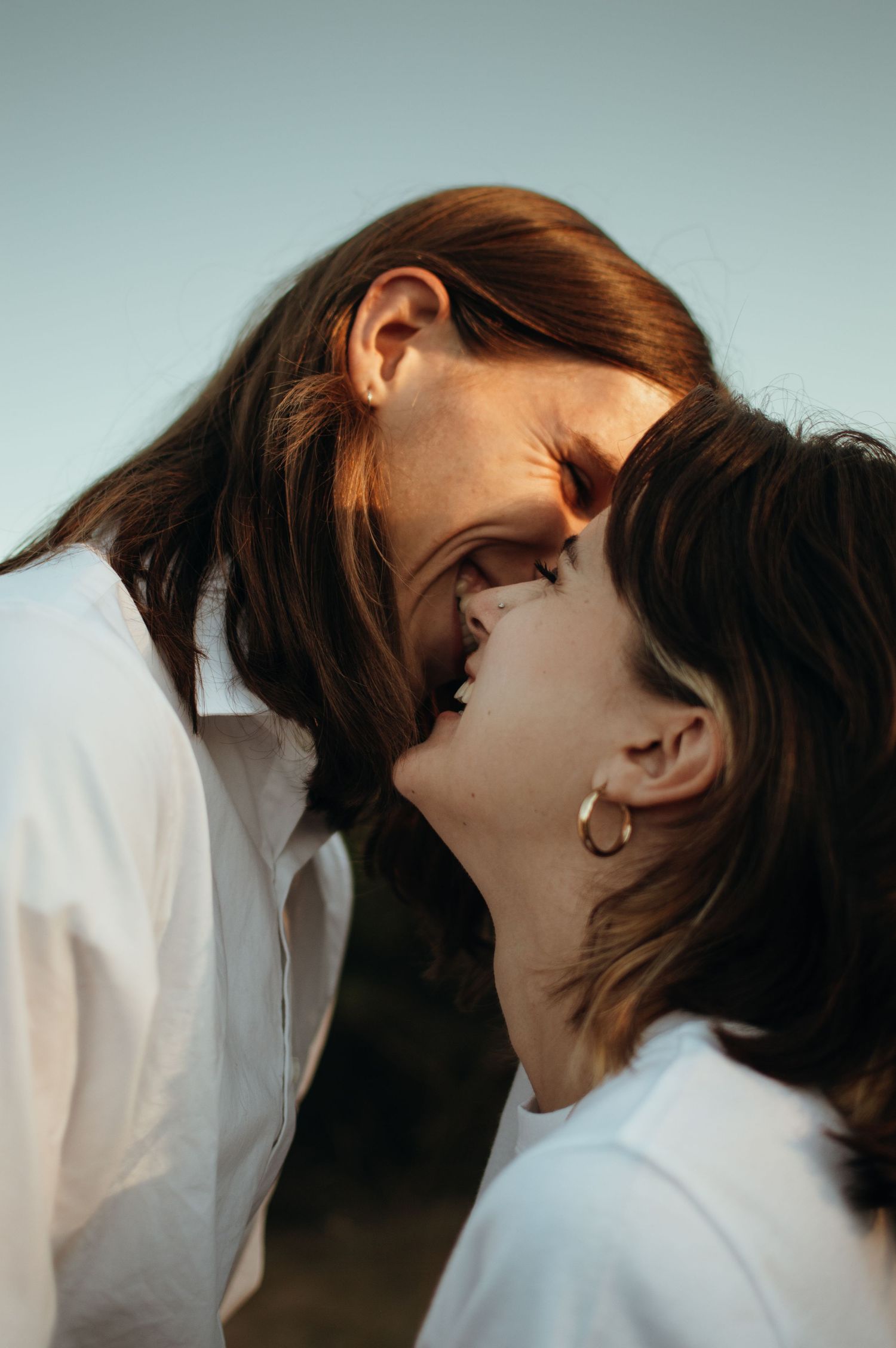 Intimate close-up portrait of couple sharing affectionate moment in natural light.